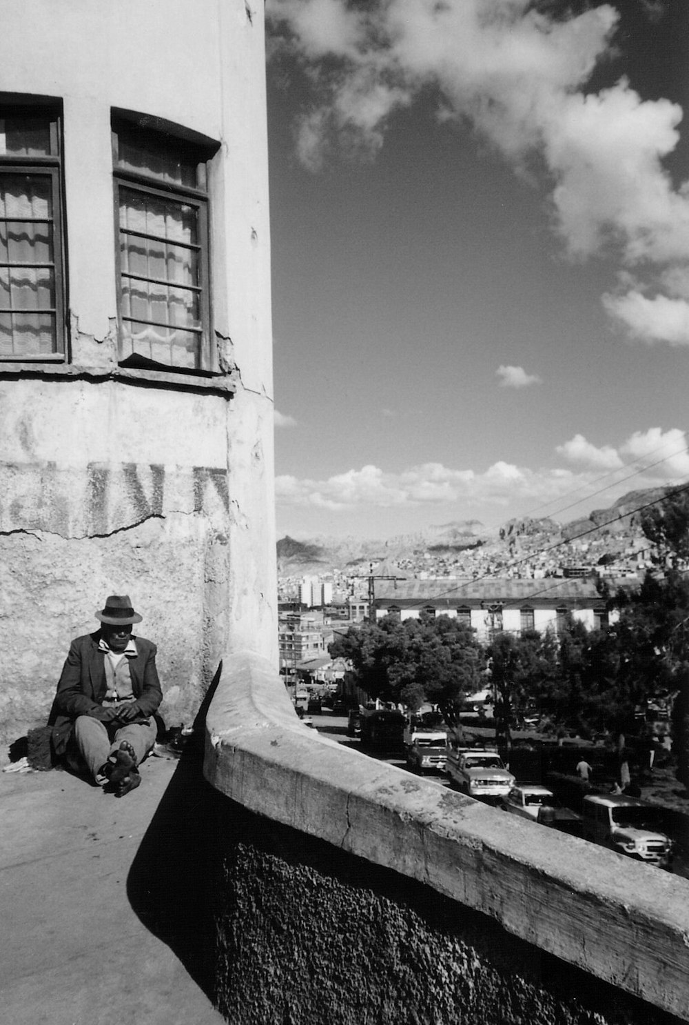 a man sitting on the side of a building