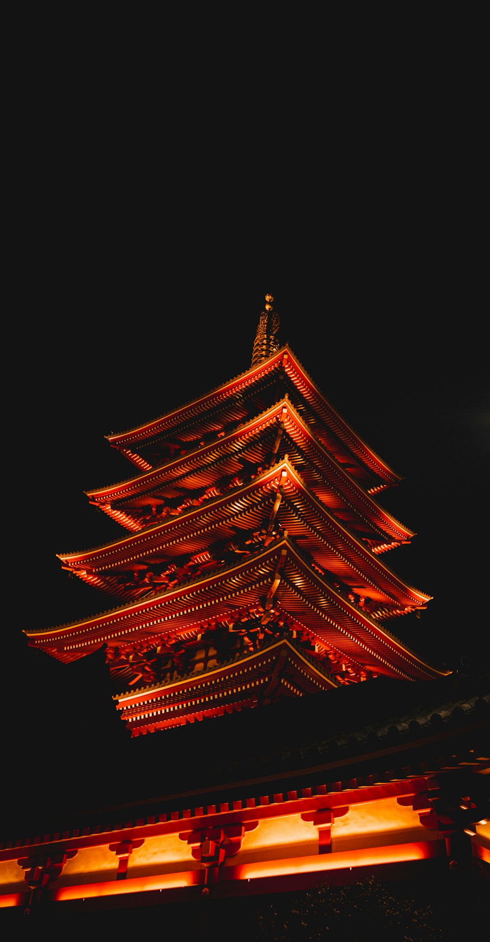 a tall building lit up in the dark