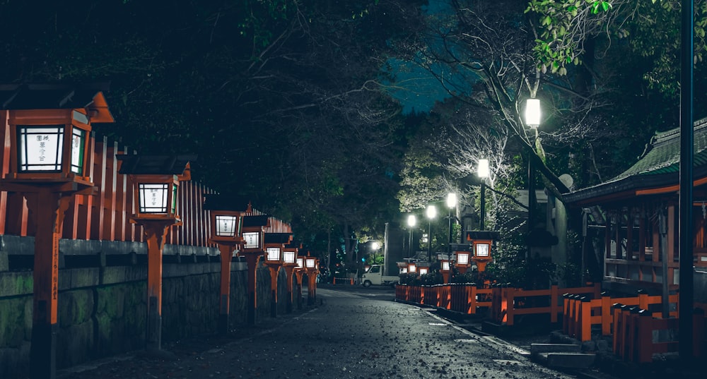 a row of wooden benches sitting next to a forest