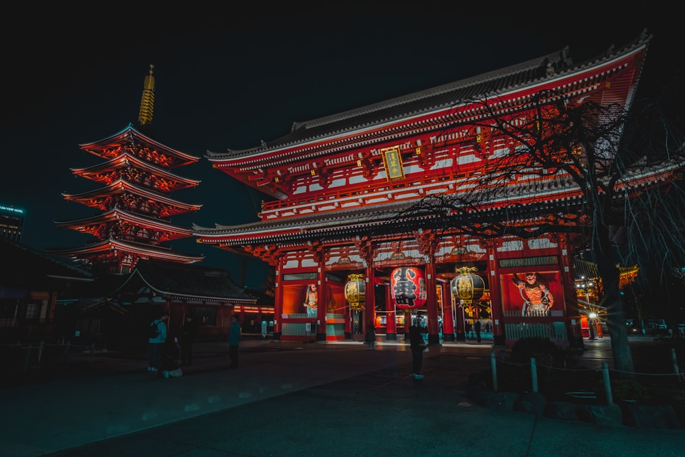 a tall building with red lights in front of it