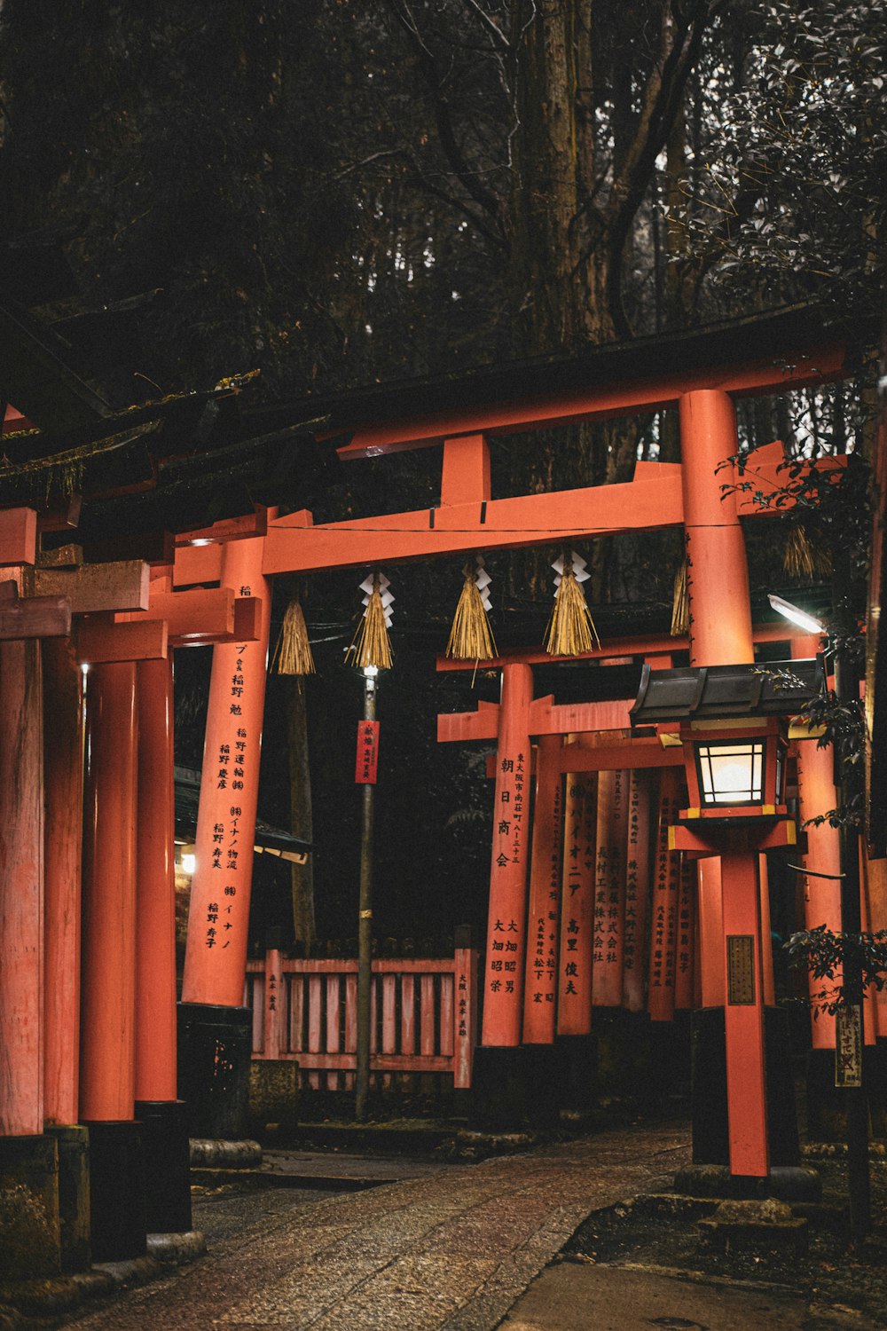 a red gate with lanterns hanging from it