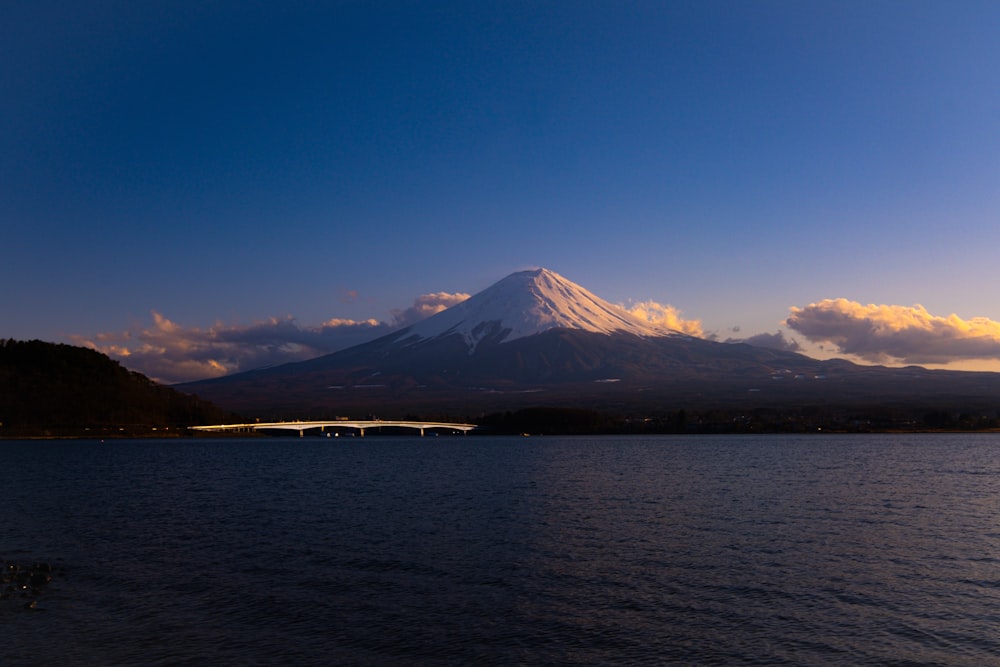 a large body of water with a mountain in the background