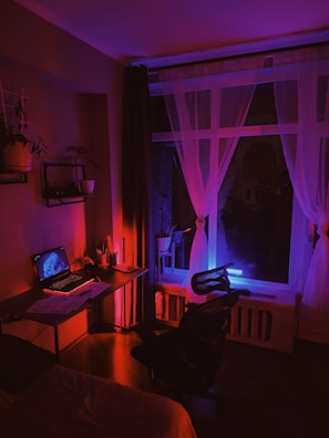 a room with a desk and a laptop on it