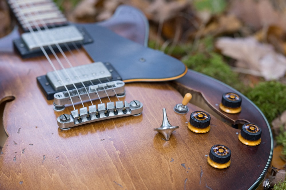 a close up of a guitar on the ground