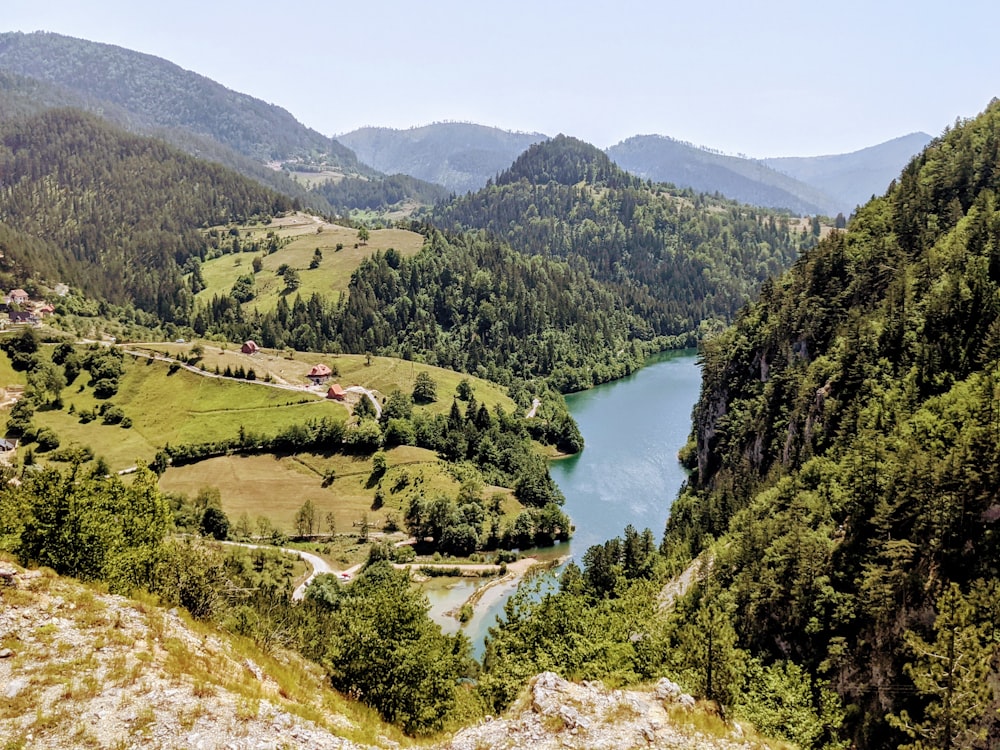 a view of a valley with a lake in the middle of it