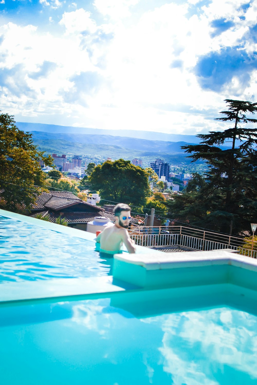 a large pool with a statue of a man sitting on top of it