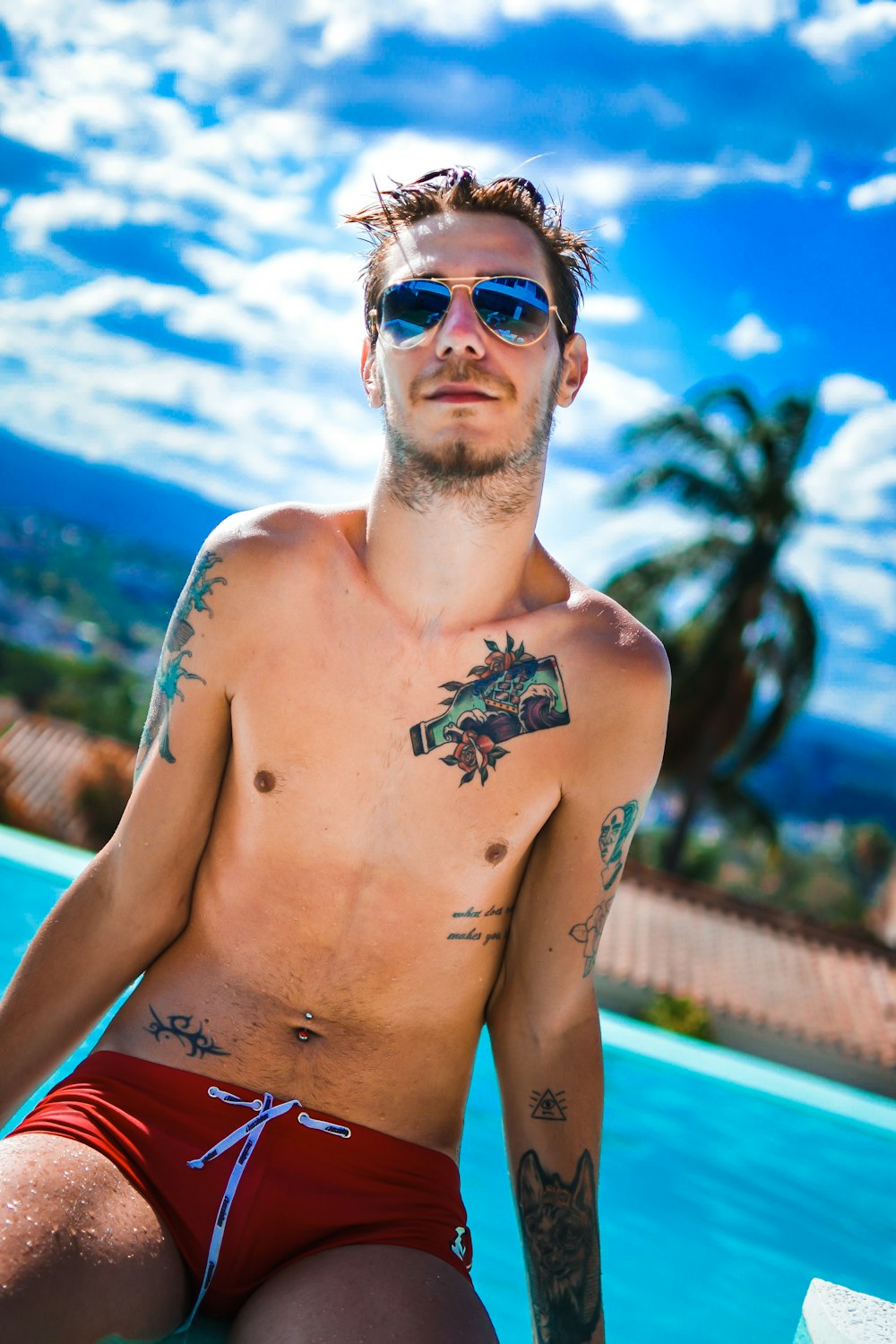 a man with a tattoo on his arm sitting in a pool