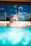 a man laying in a swimming pool wearing sunglasses