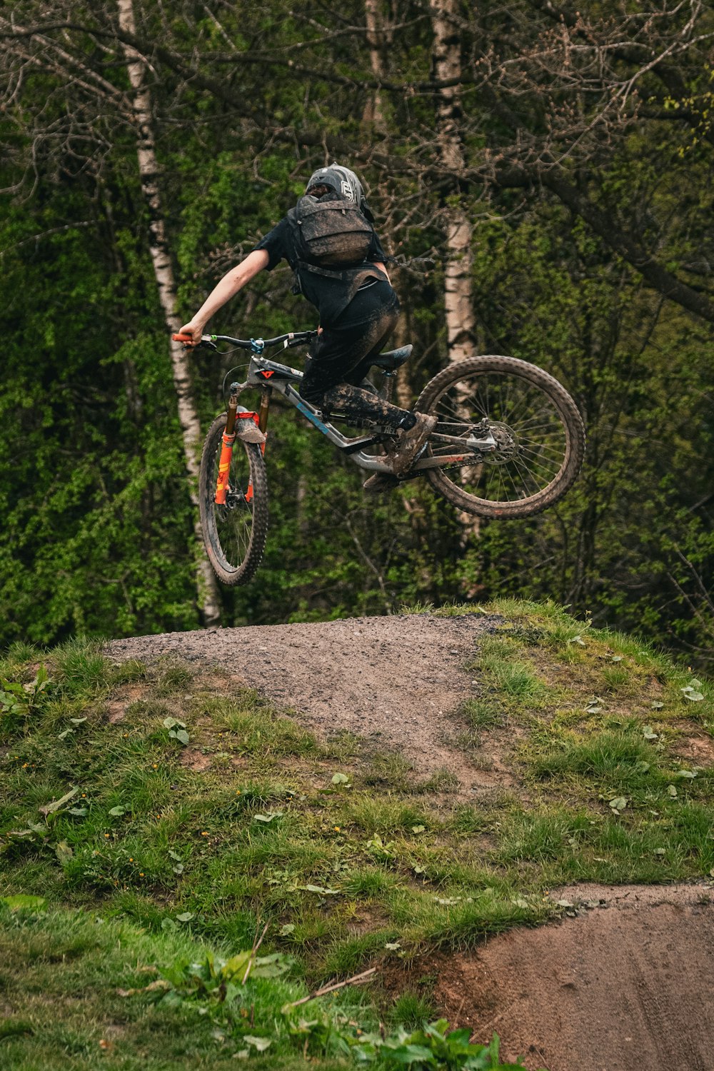 a man riding a bike up the side of a hill