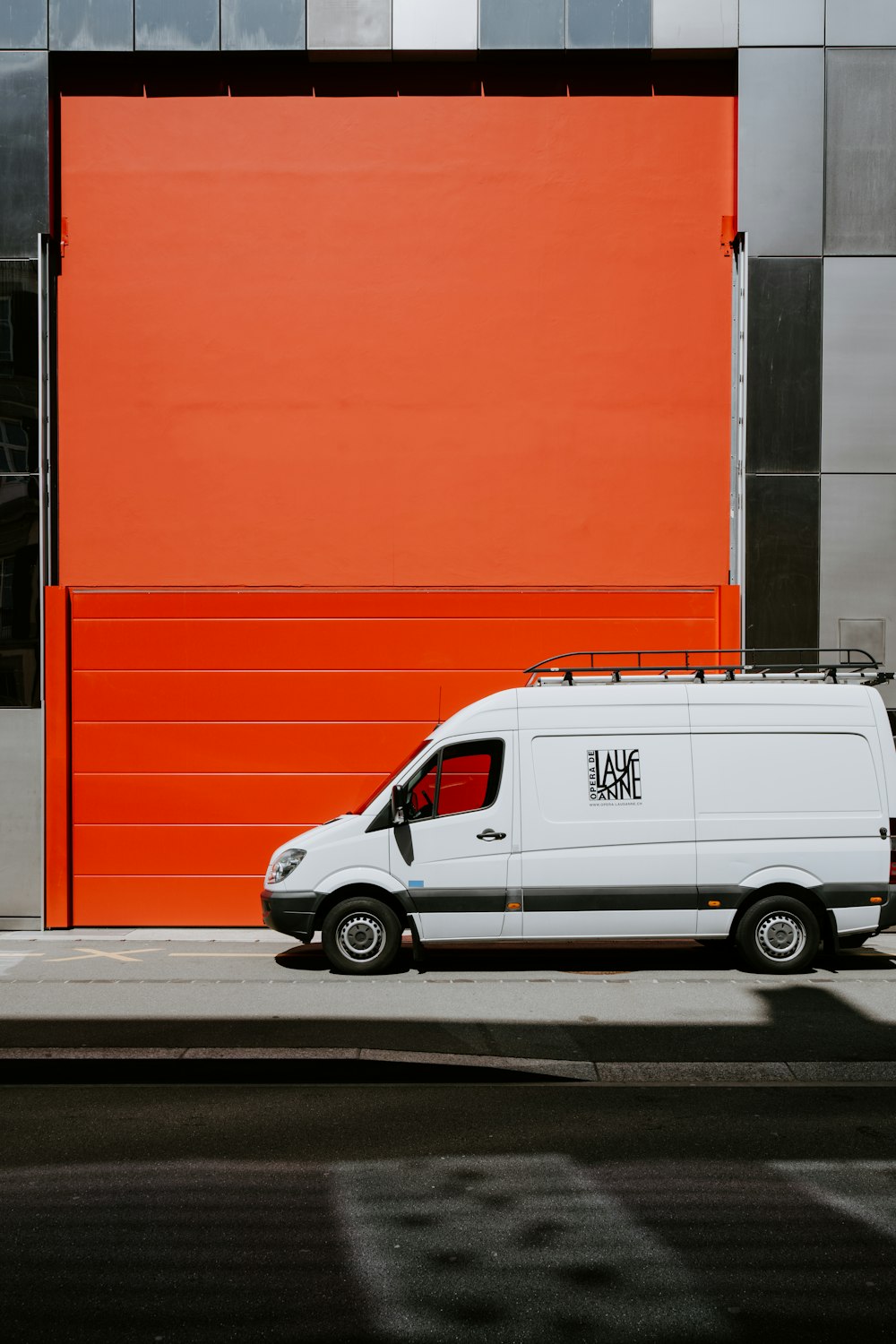 a white van parked in front of a building