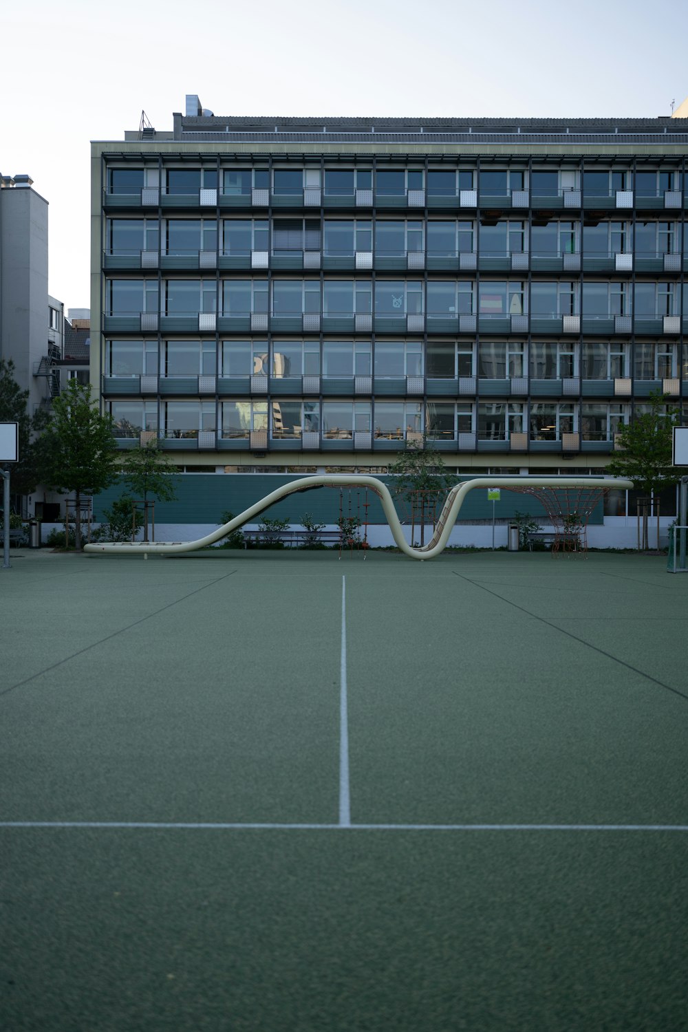 a tennis court with a building in the background