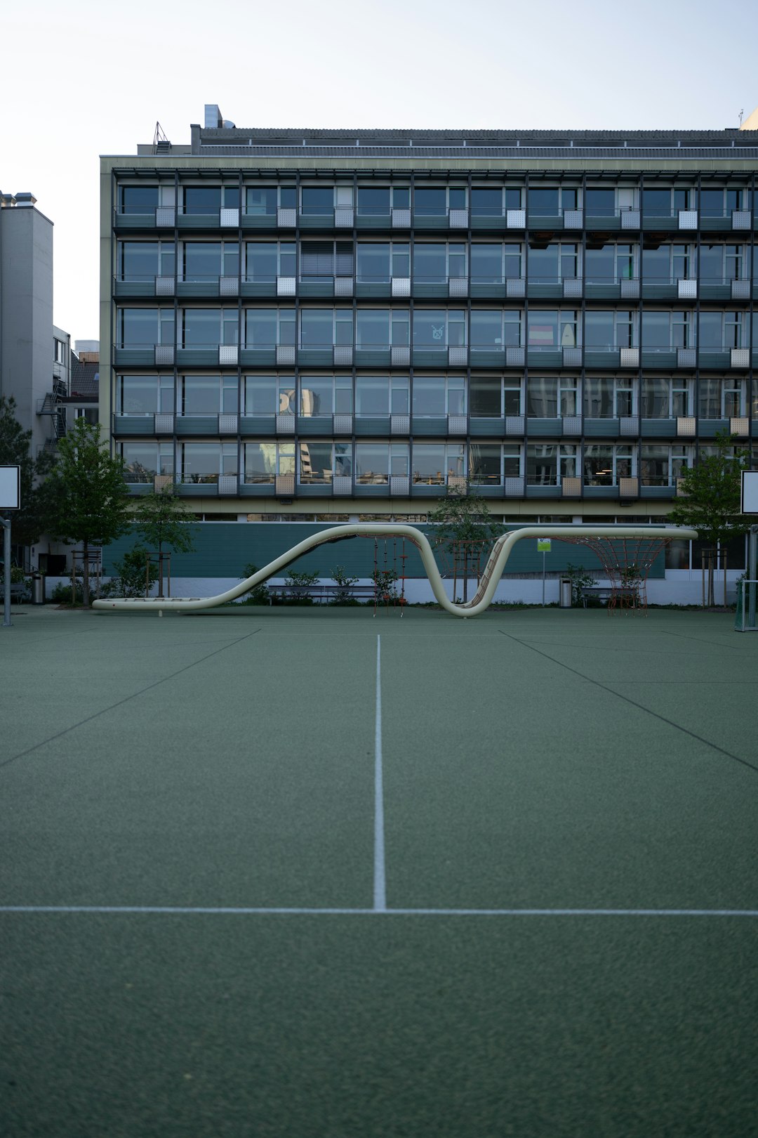 a tennis court with a building in the background