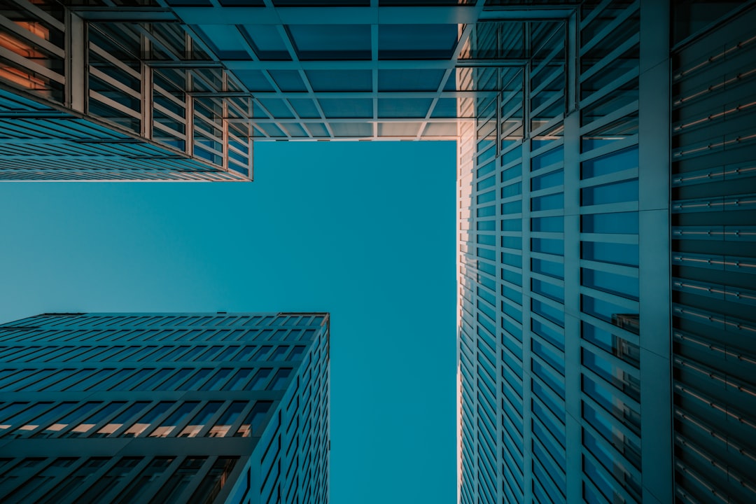 a group of tall buildings with a blue sky in the background