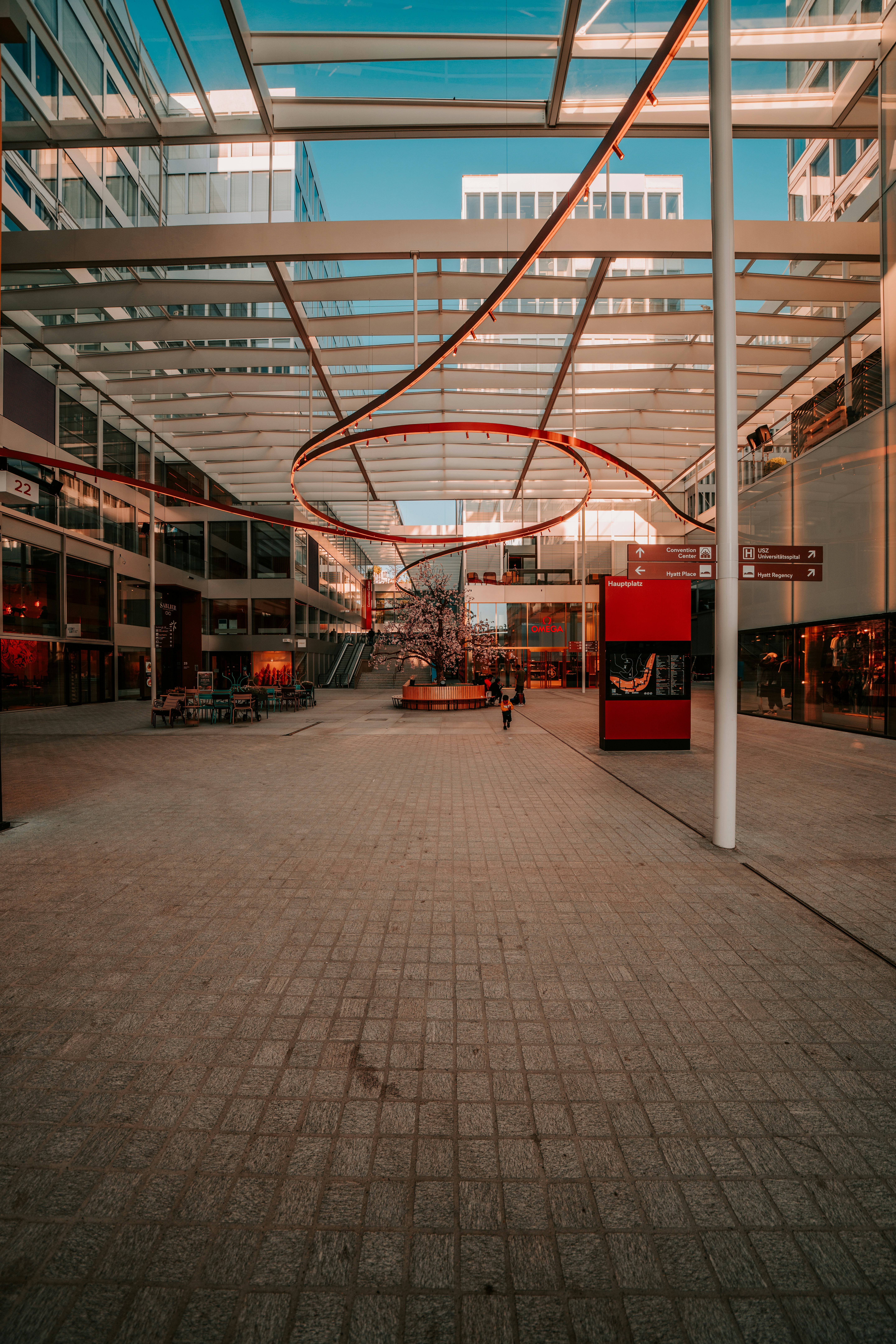 a person walking down a walkway in a building