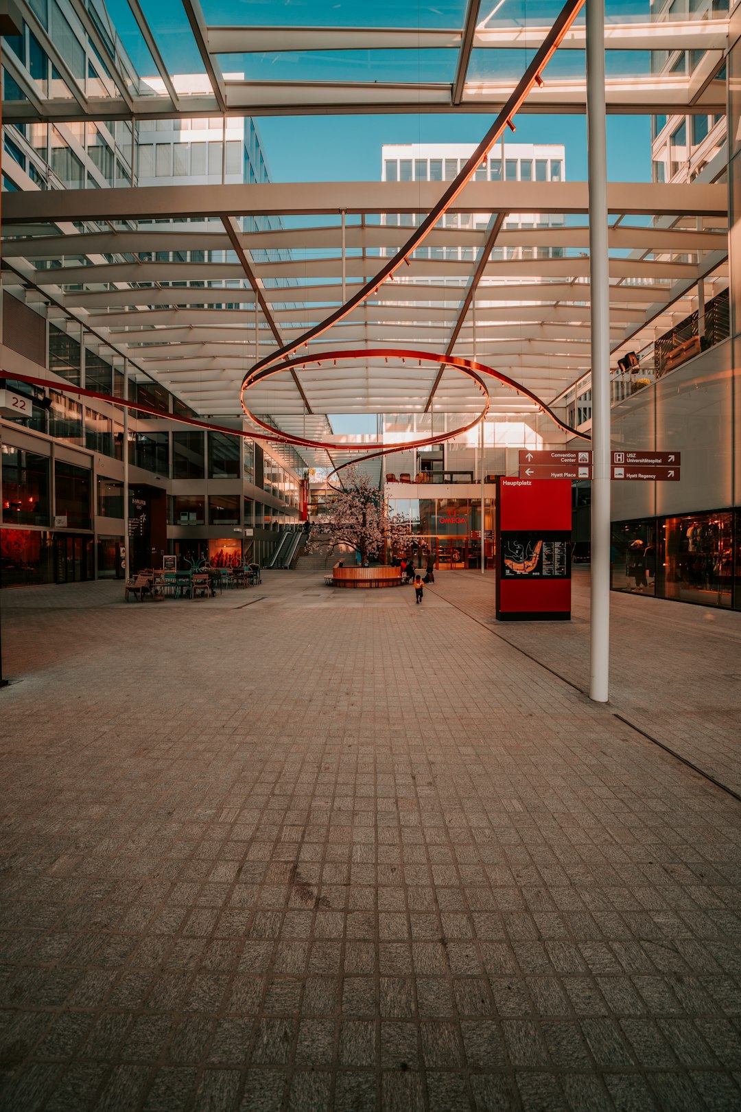 a person walking down a walkway in a building