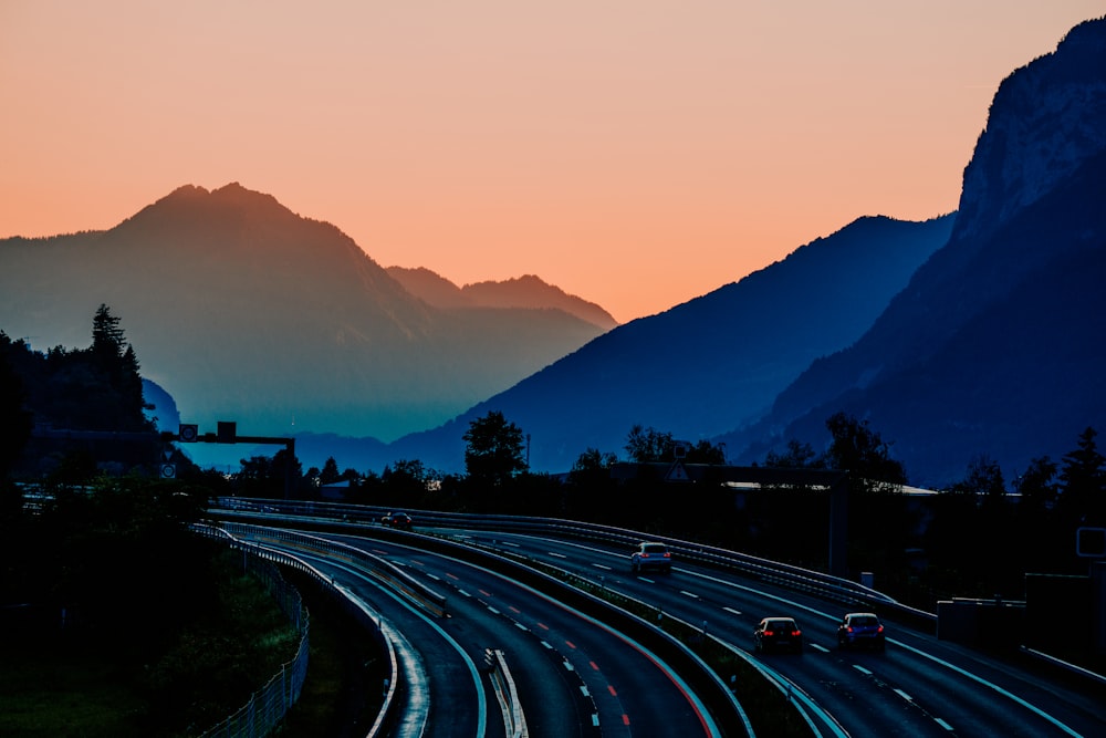 a view of a highway with mountains in the background