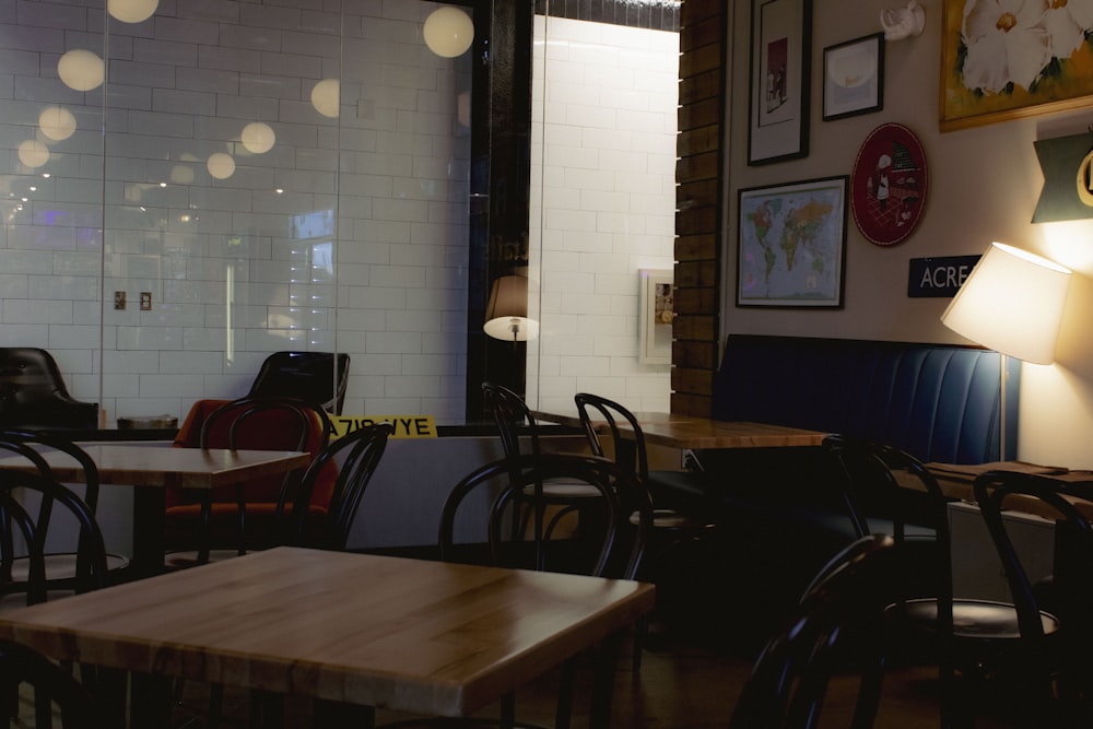 a restaurant with tables, chairs, and pictures on the wall