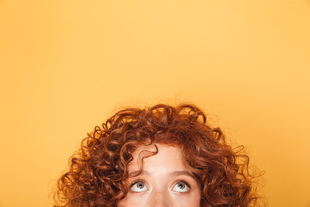 a close up of a person with curly hair