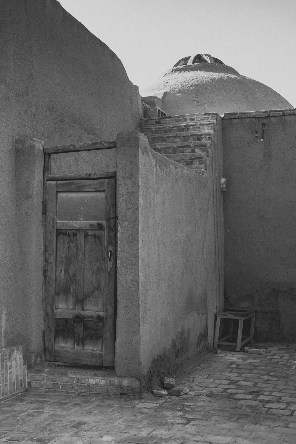 a black and white photo of a door and a building