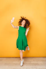 a woman in a green dress is jumping in the air