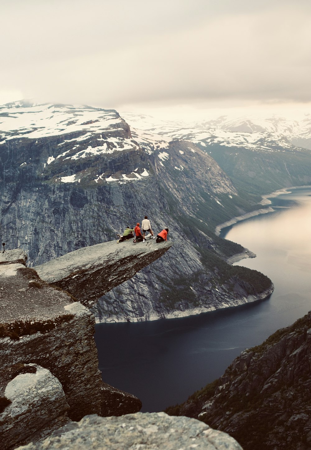 a group of people sitting on top of a mountain