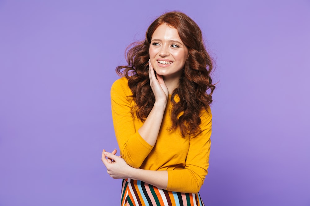 a woman posing for a picture with her hand on her chin