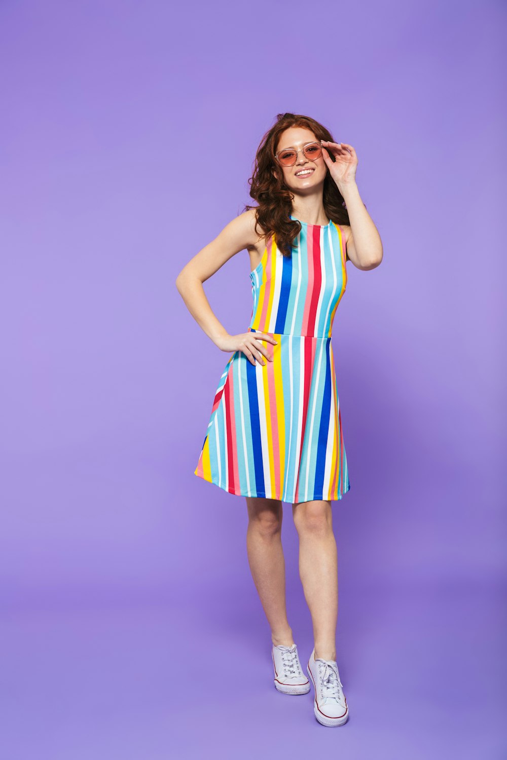 a woman in a colorful dress posing for a picture