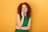 a woman in a green dress is smiling