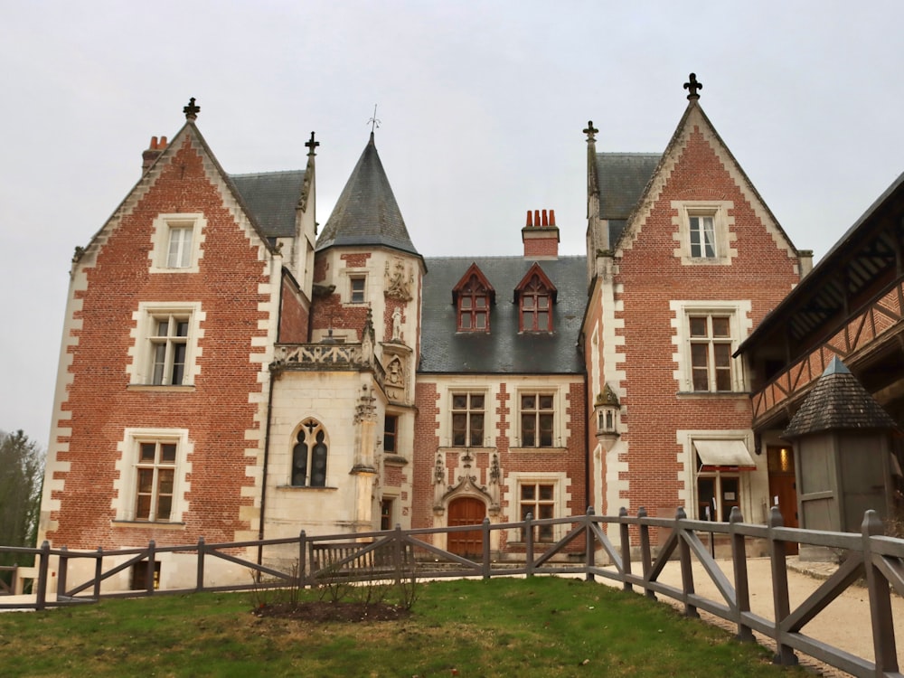 a large red brick building with a fence in front of it