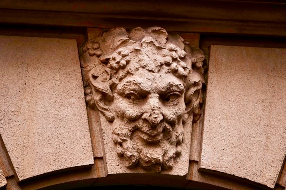 a close up of a face on a building