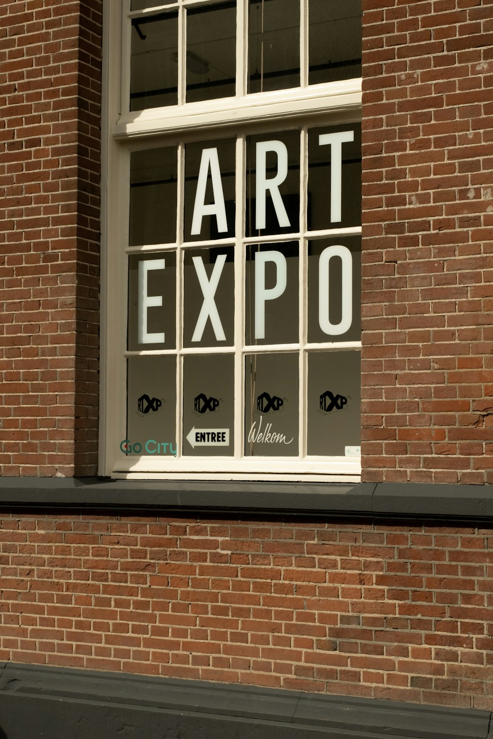a brick building with a window that says art expo