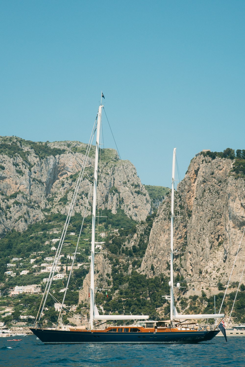 a sailboat in a body of water with mountains in the background