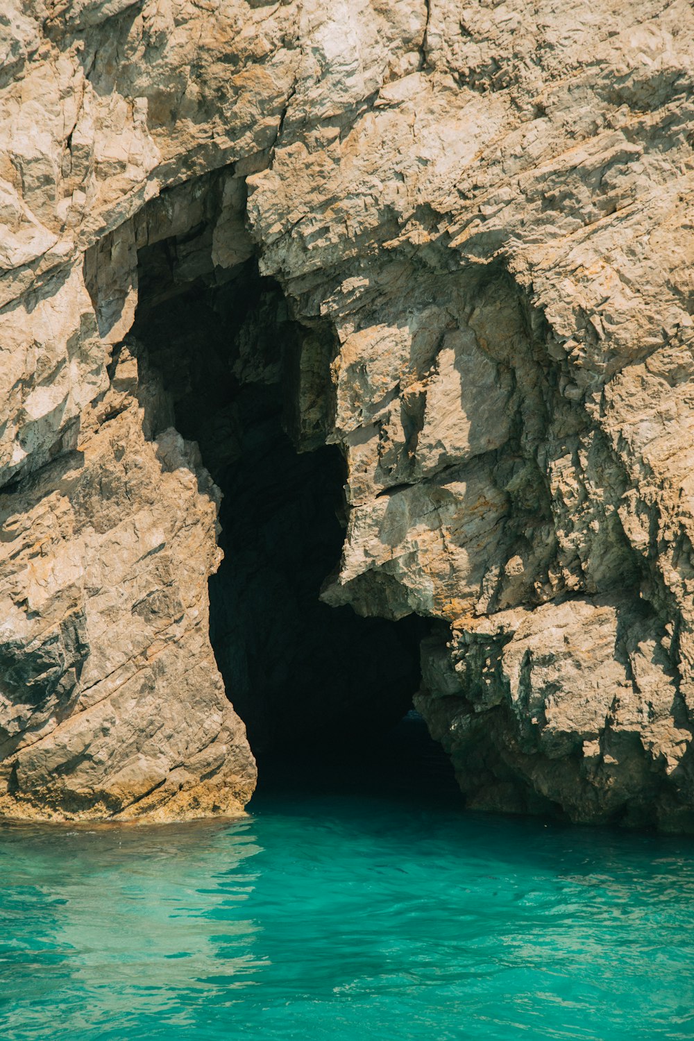 a large rock formation next to a body of water