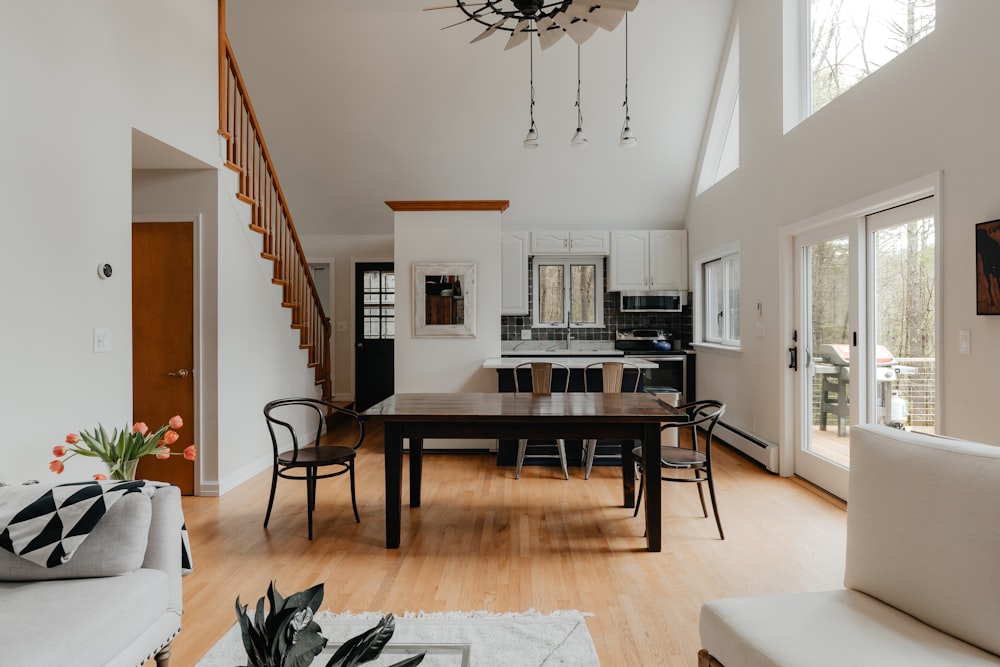 a living room filled with furniture and a dining room table