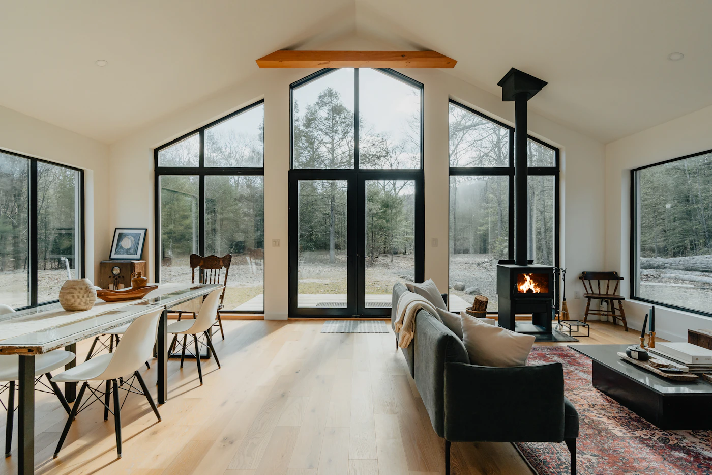Bright living room with arched windows and a wood stove