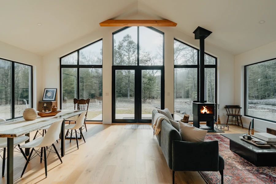 Bright living room with arched windows and a wood stove