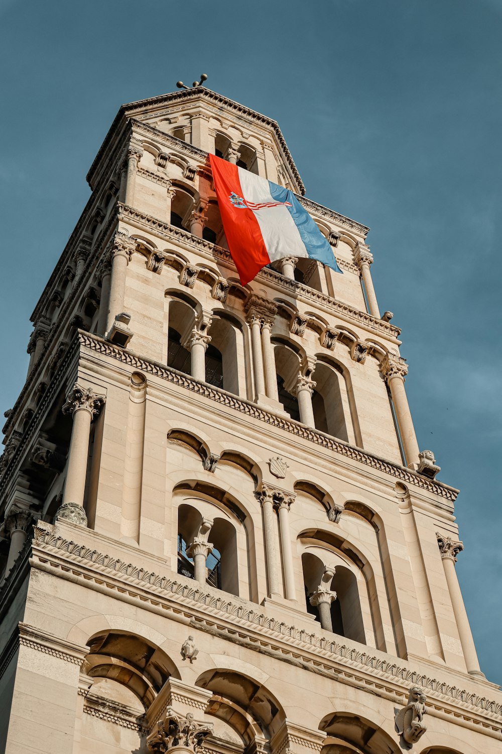 a tall tower with a flag on top of it