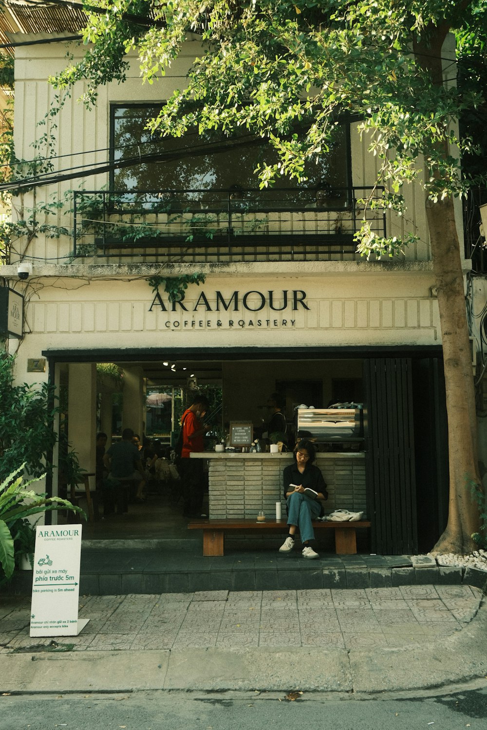 a person sitting on a bench in front of a store