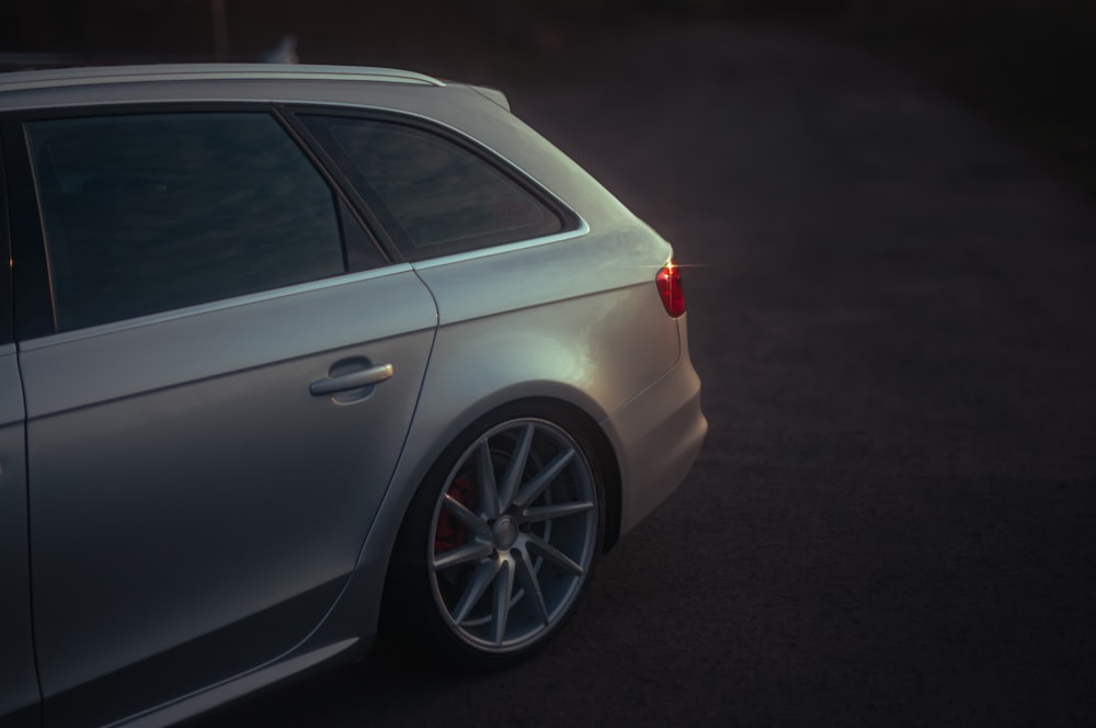 a white car parked on the side of a road