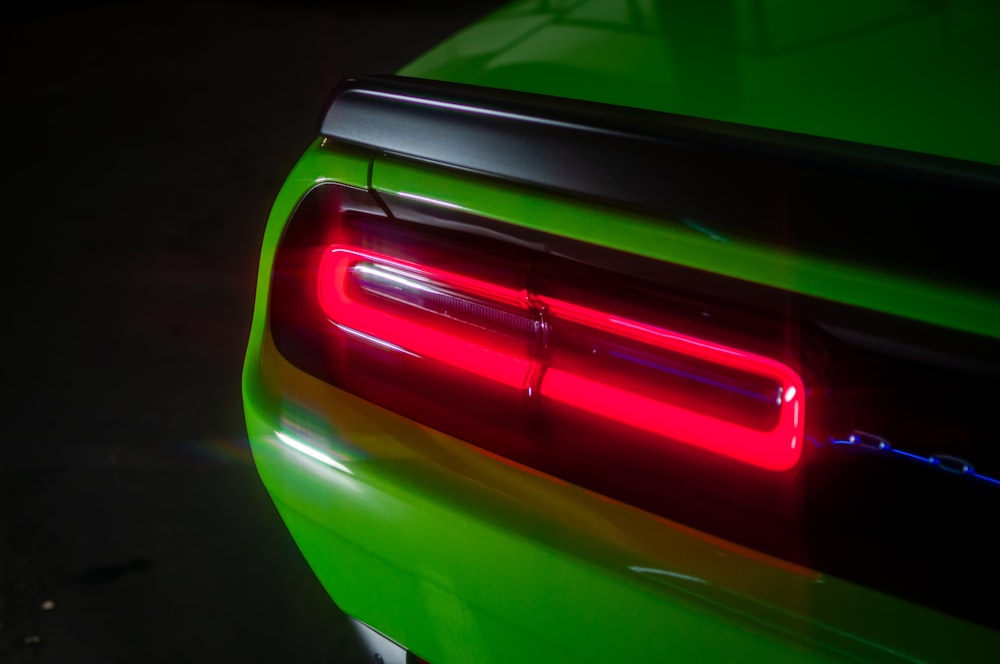 the tail light of a green car in the dark