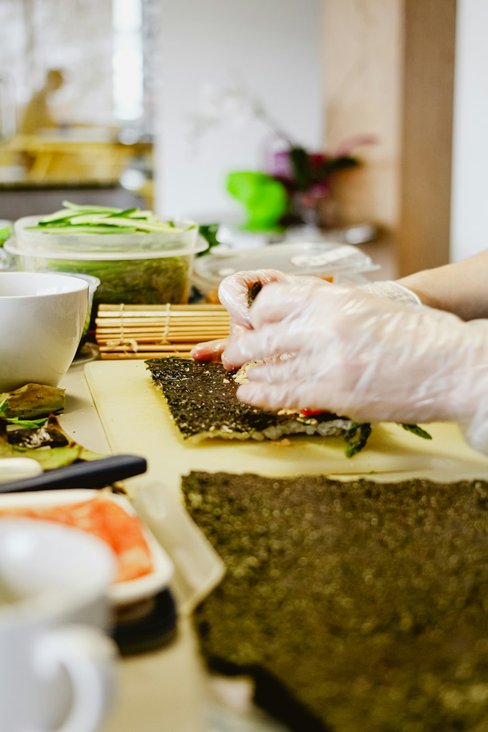 a person in white gloves is preparing food