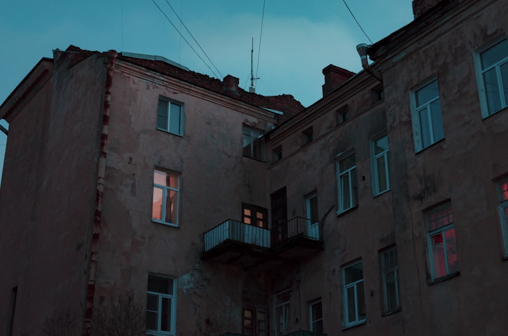 a tall building with windows and a sky in the background