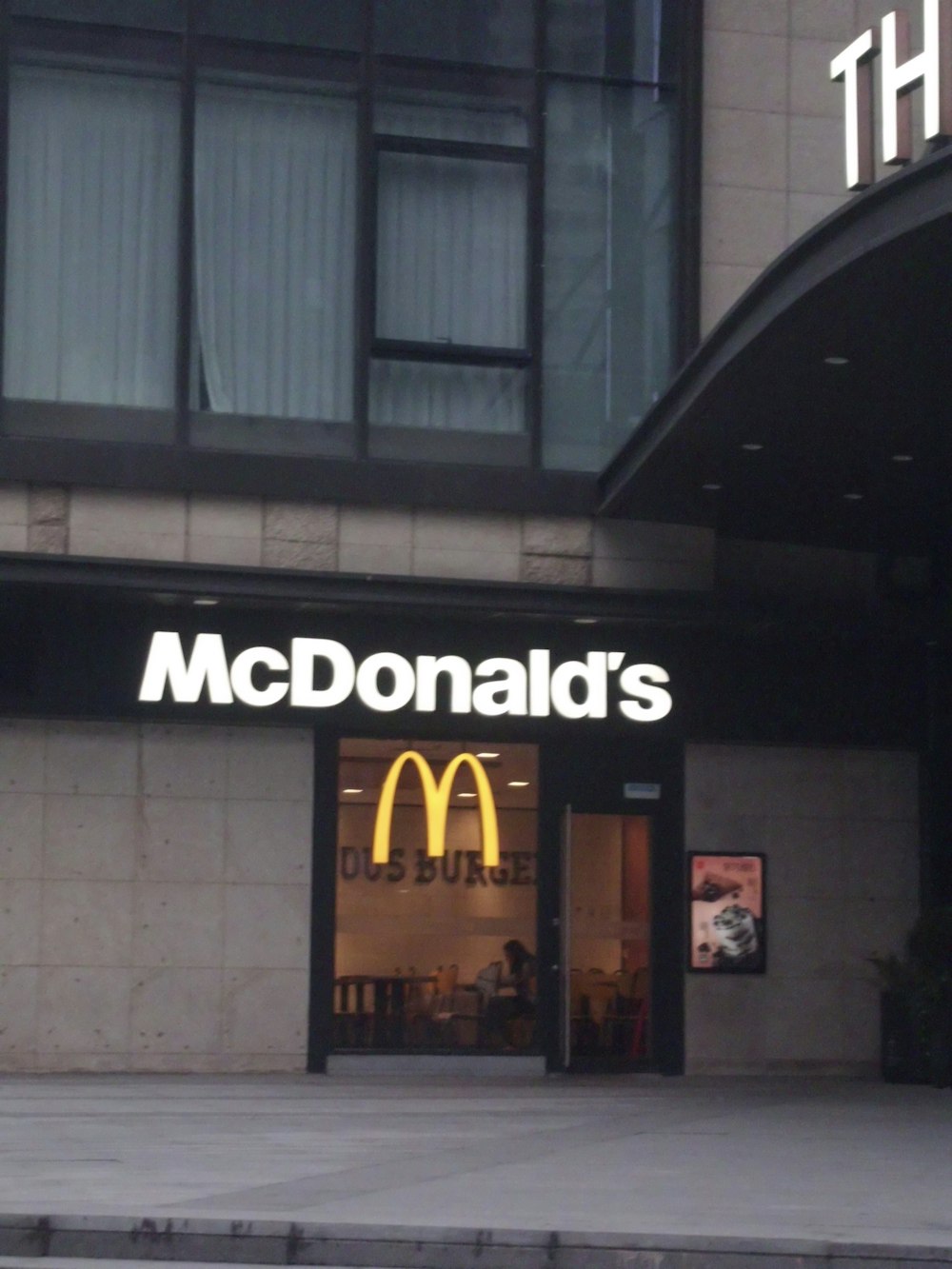 a mcdonald's restaurant is shown in front of a building