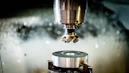 a machine that is cutting a piece of metal