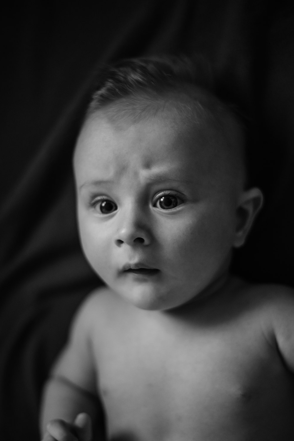 a black and white photo of a baby