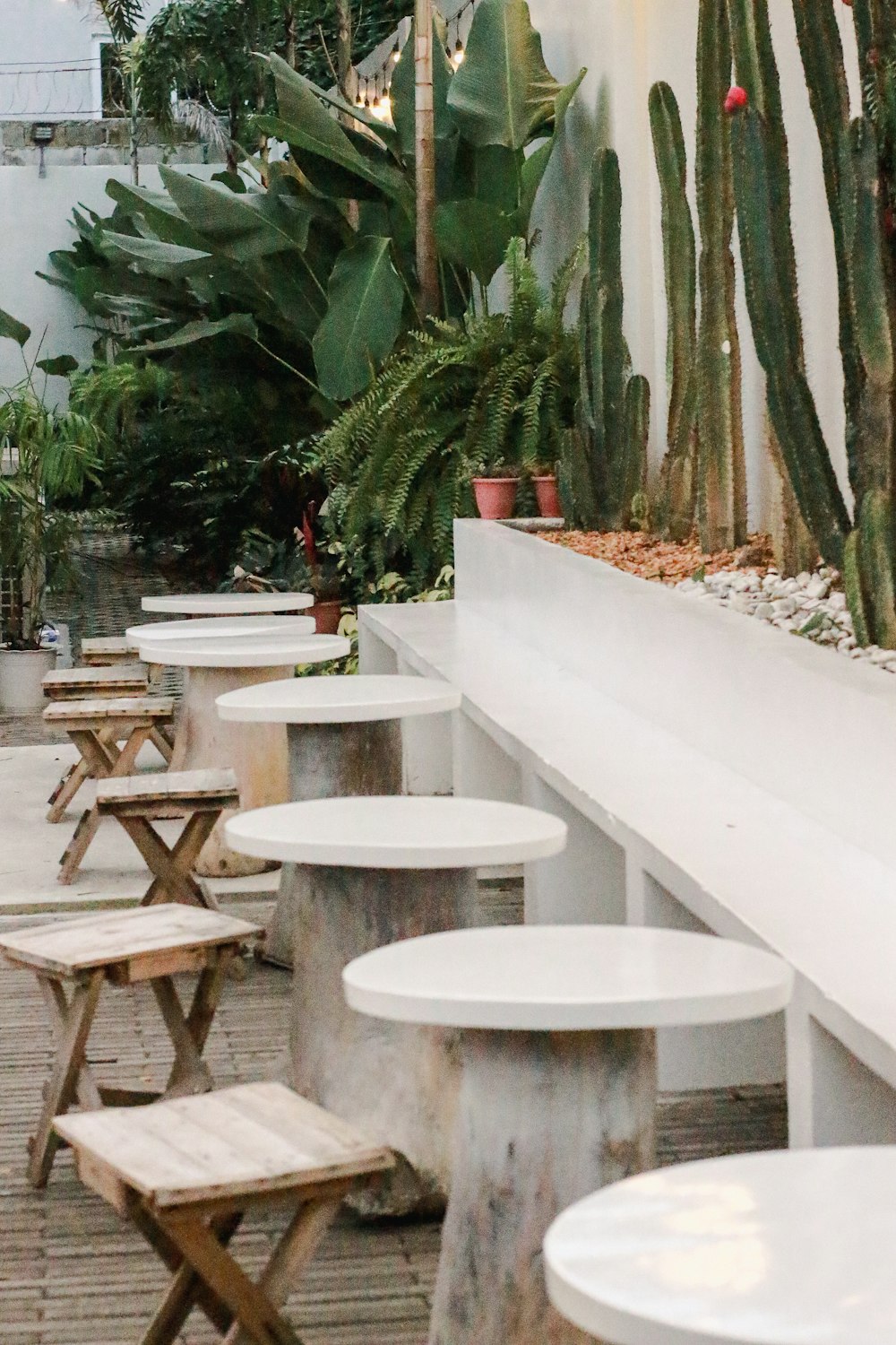 a row of white tables sitting next to each other