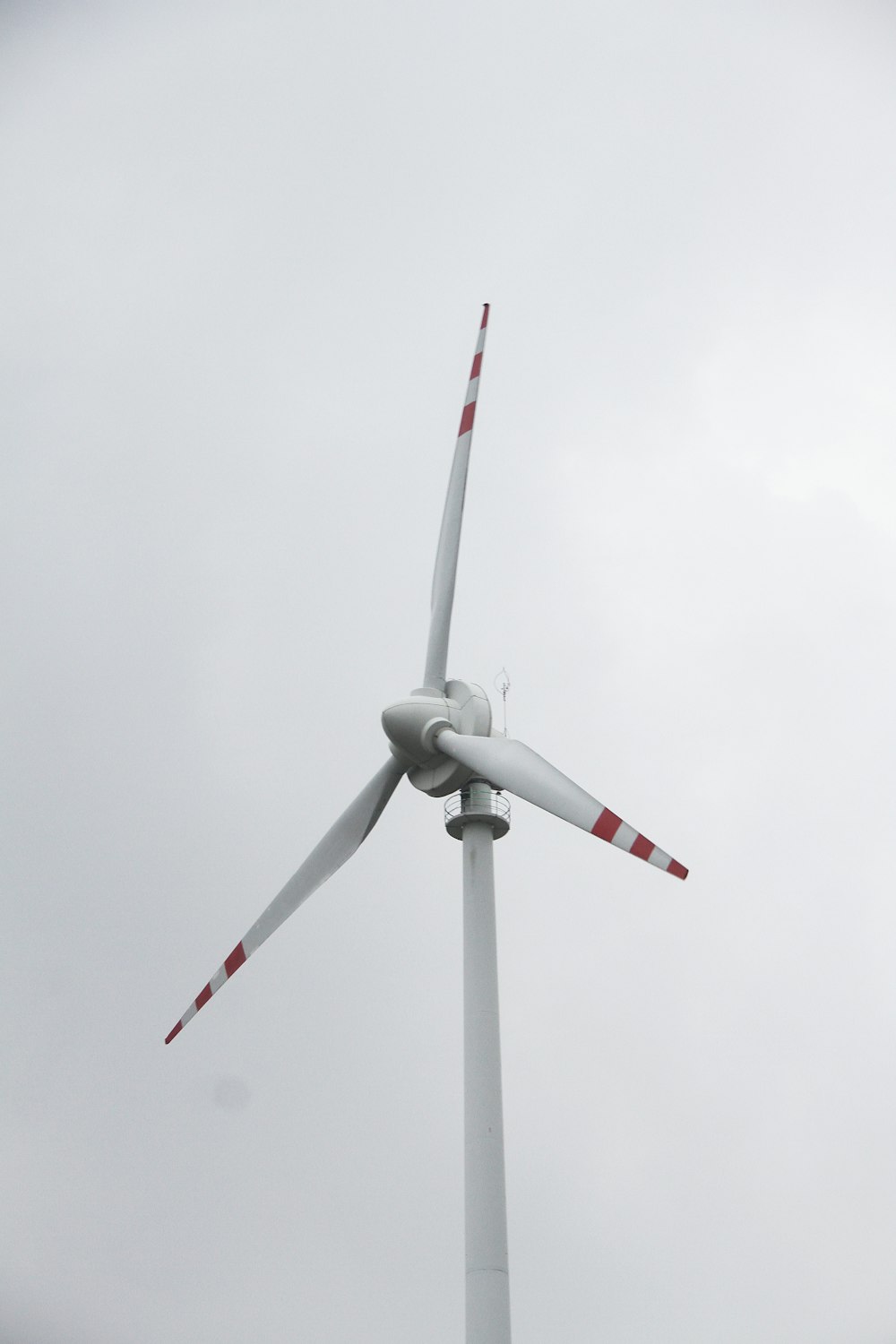 a wind turbine is shown against a cloudy sky