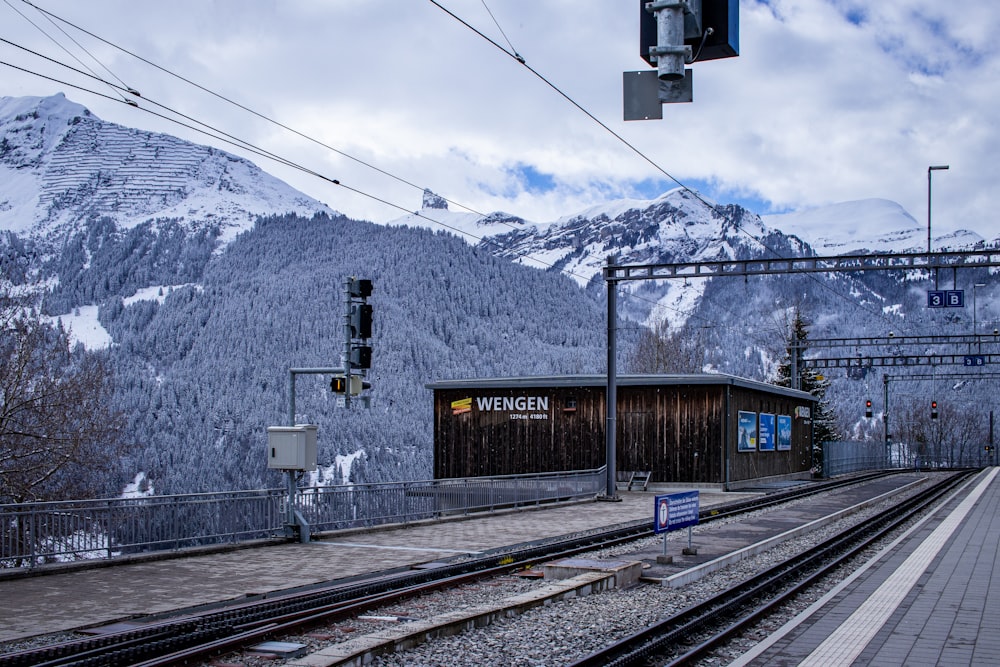 a train station with mountains in the background