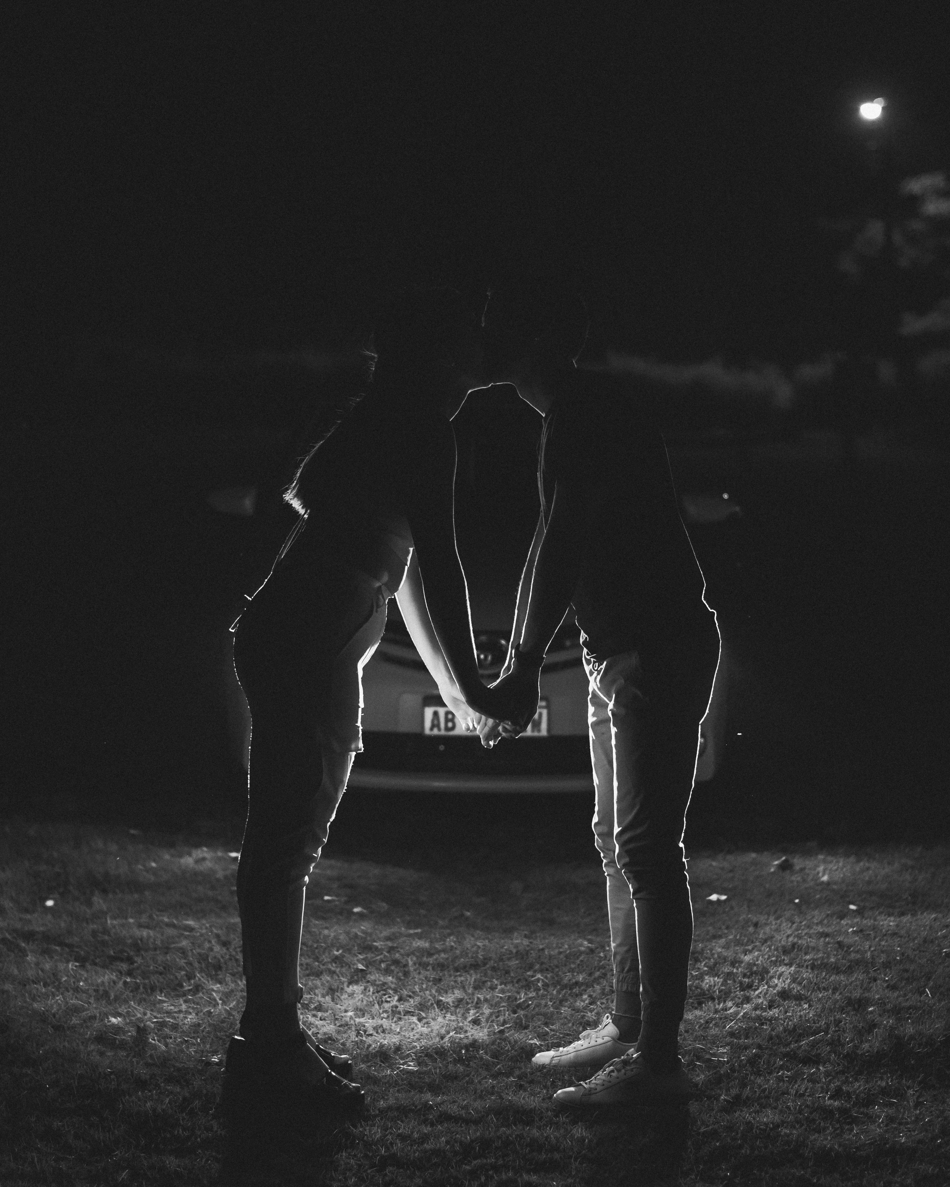a couple of people that are standing in the grass