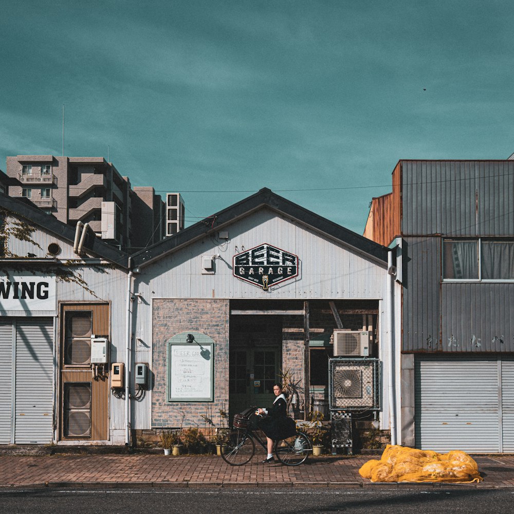 a person riding a bike in front of a building